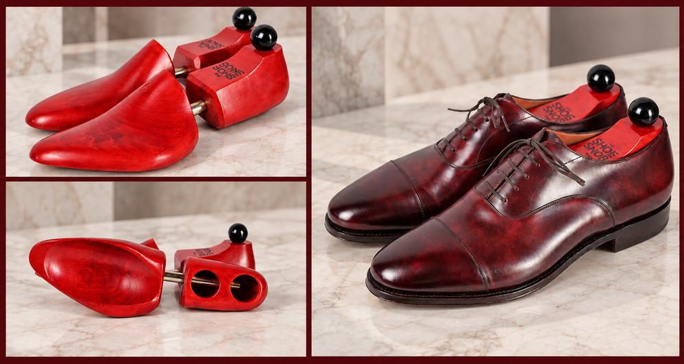 A pair of polished burgundy leather dress shoes with matching red wooden shoe trees, featured in a guide to shoe trees.