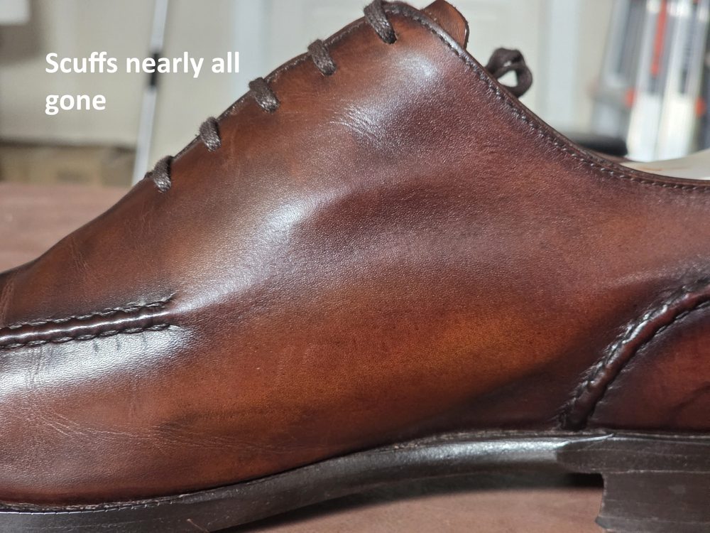 A polished brown leather shoe with nearly all scuffs removed.