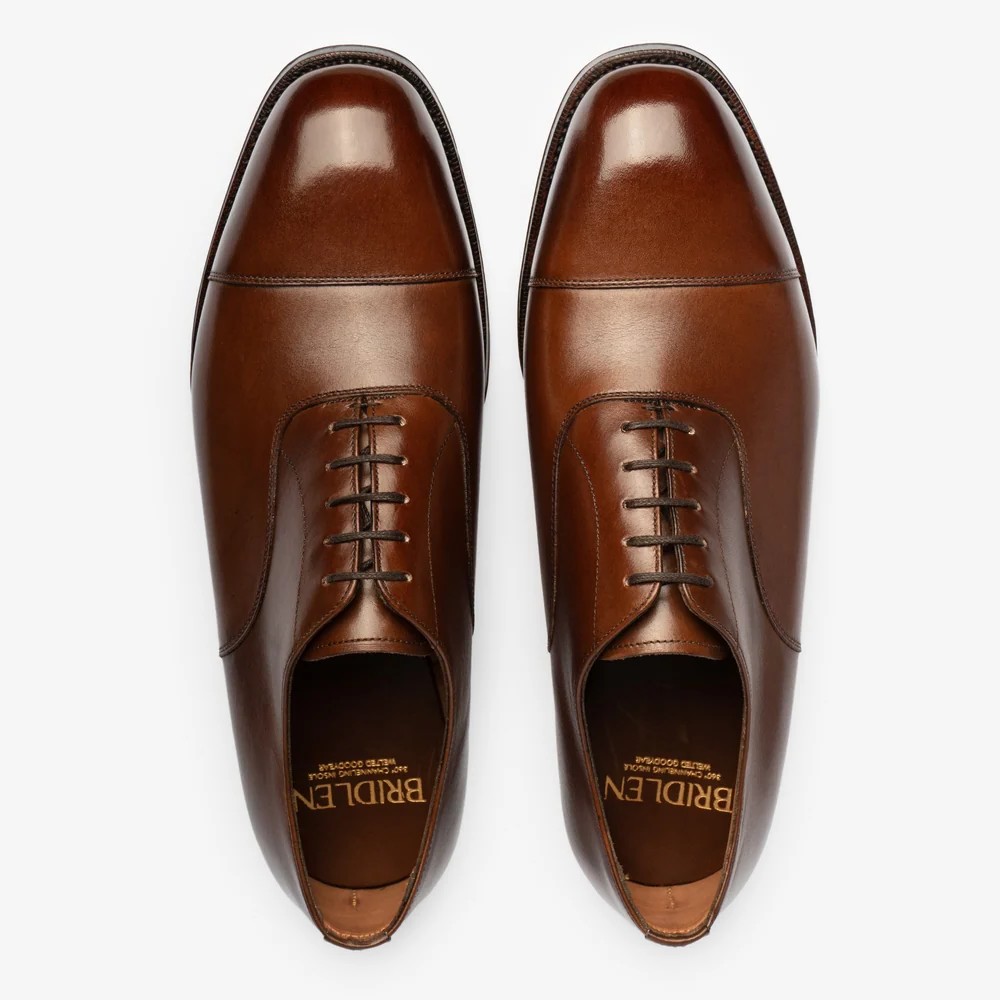 A pair of brown leather Oxford shoes with a polished finish and closed lacing.