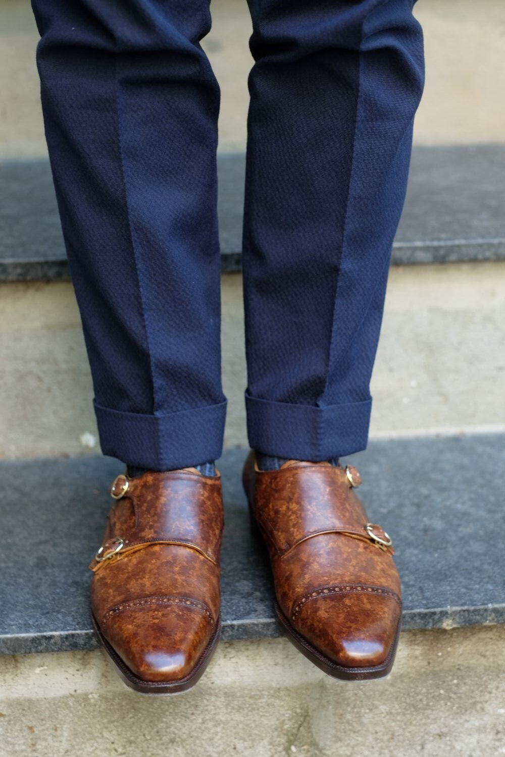 brown shoes with a navy suit