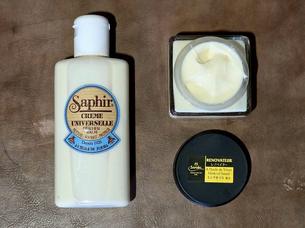 Three shoe care products are displayed: a bottle of Saphir leather balm, a jar of cream, and a tin of mink oil, highlighting common shoe shine don'ts.