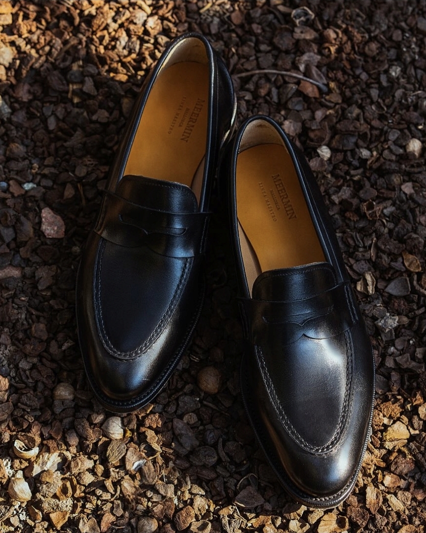 A pair of black leather loafers with a sleek design and subtle stitching details.