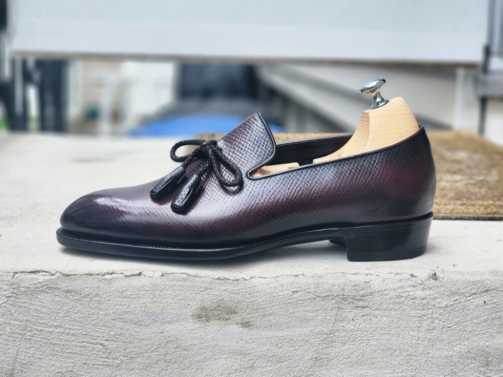 Burgundy Hatchgrain String tassel loafers side profile