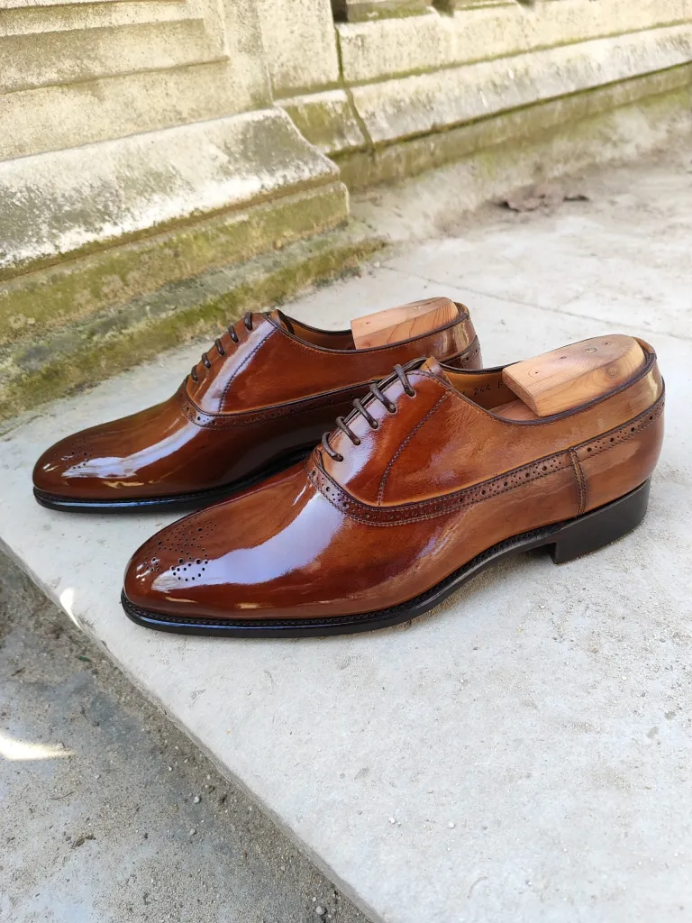 A pair of polished brown leather dress shoes for the shoe shining championships 2026 finalists