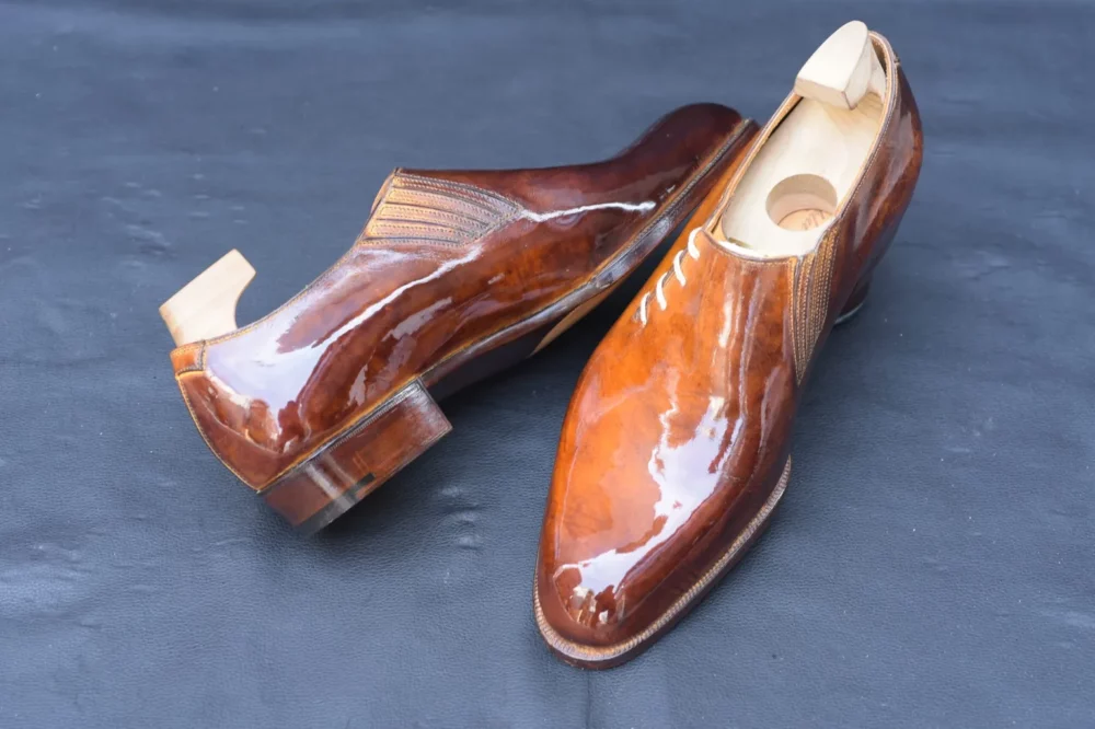 A pair of polished brown leather side laces dress styles for the shoe shining championships 2026 finalists