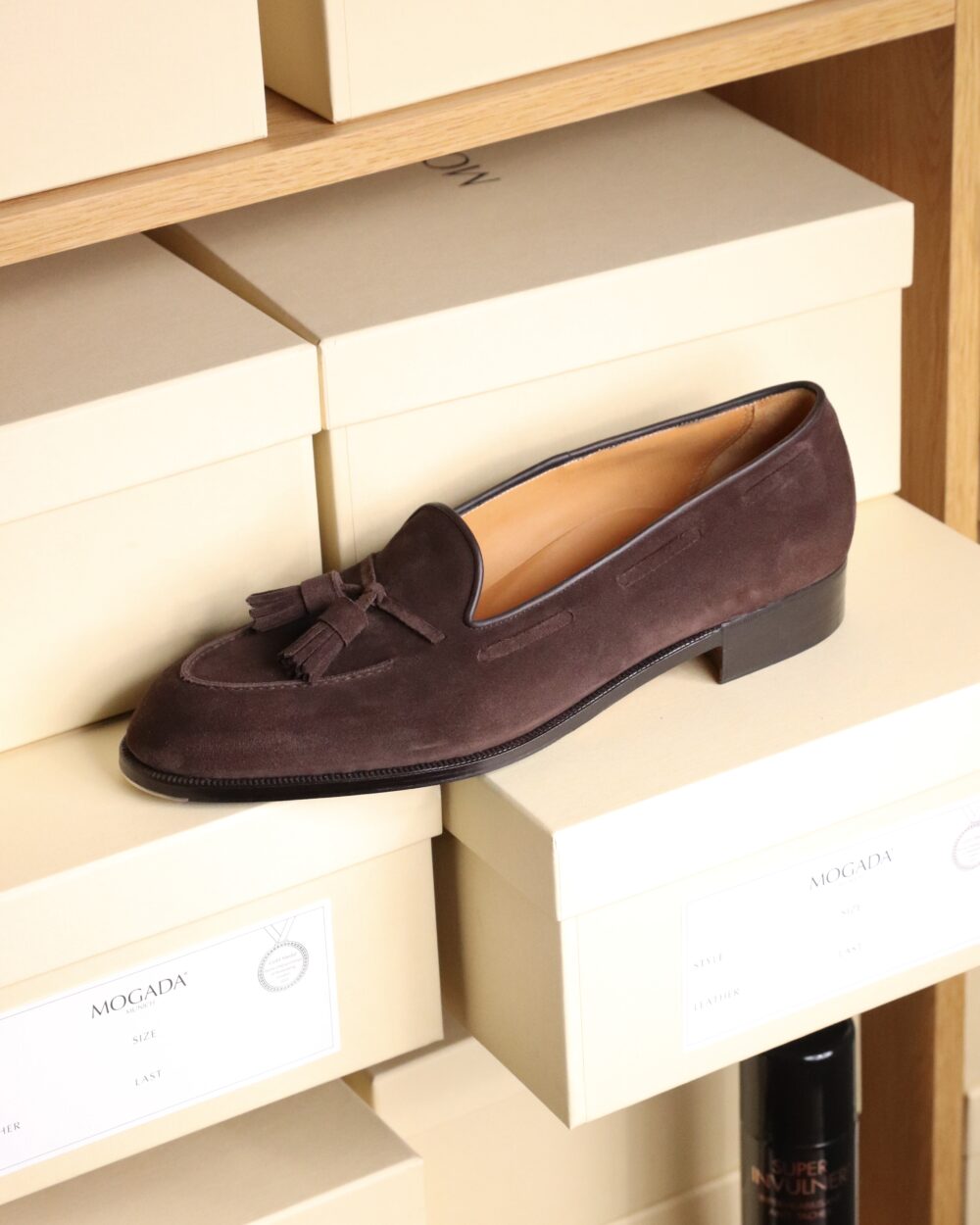 A dark brown suede loafer with tassels by Louis Lampertsdörfer