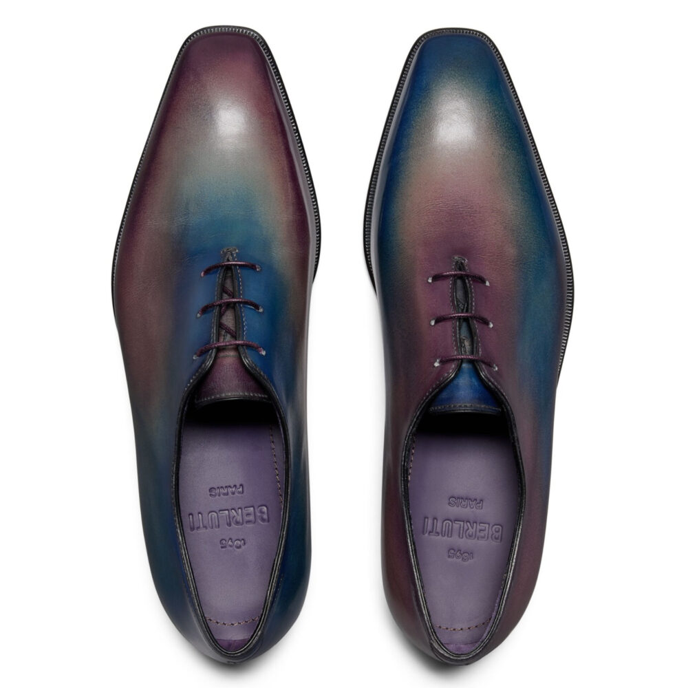 Two pairs of leather dress shoes in a gradient of purple and blue tones with black laces.