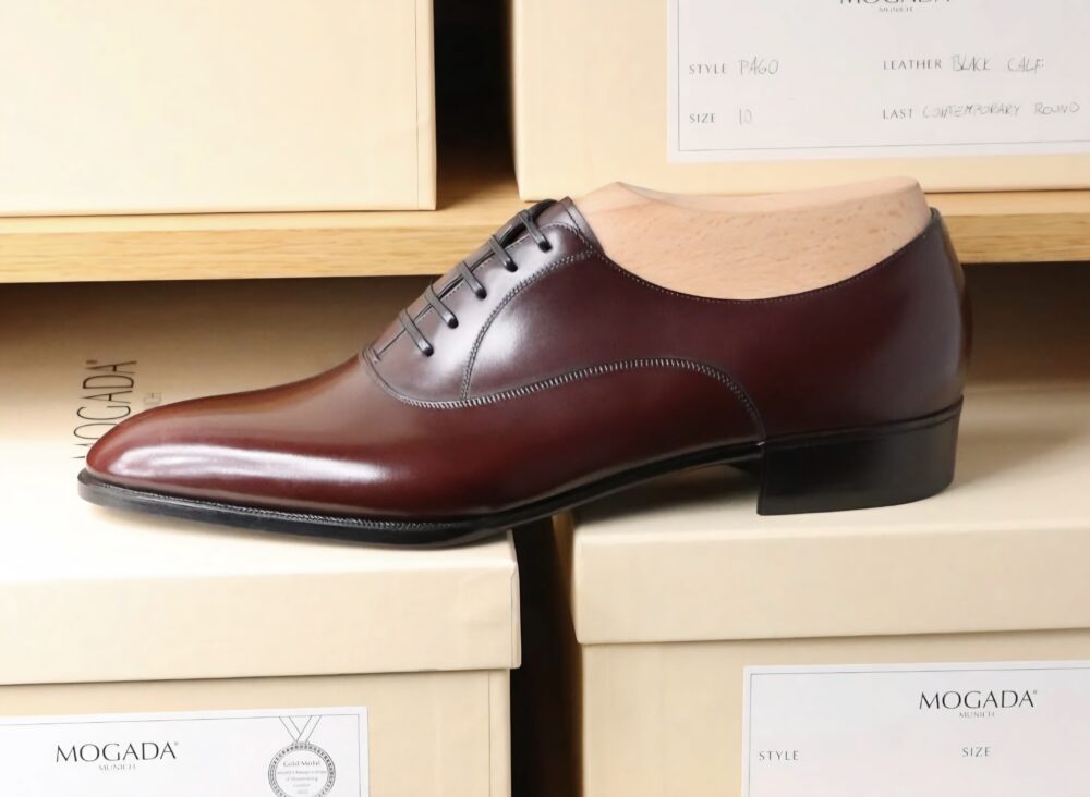 A polished burgundy leather dress shoe with a rounded toe and laces by Louis Lampertsdörfer