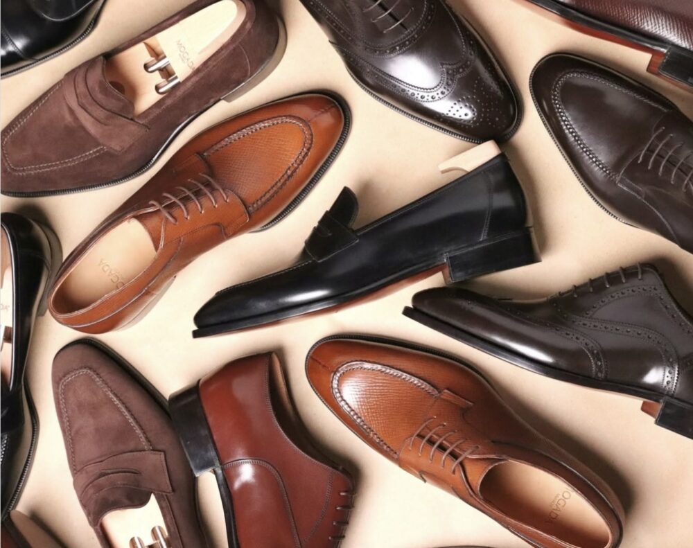 A variety of men's dress shoes in shades of brown and black, featuring leather and suede materials.