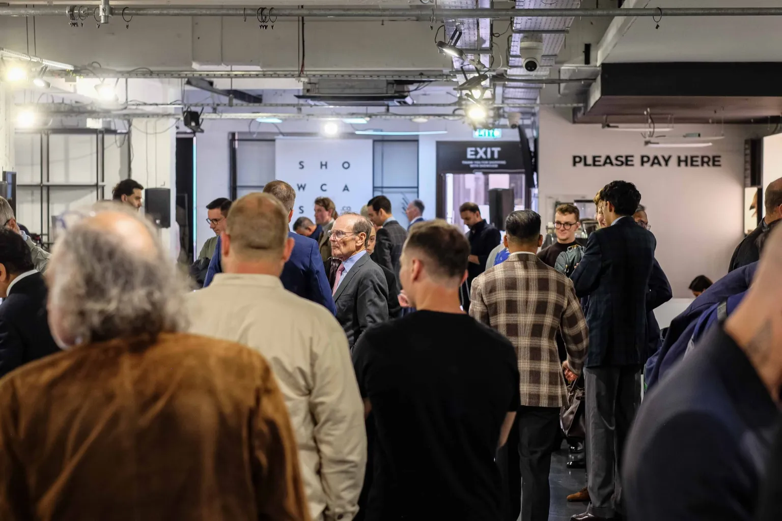 A crowd of people in business attire at the London Super Trunk Show 2025