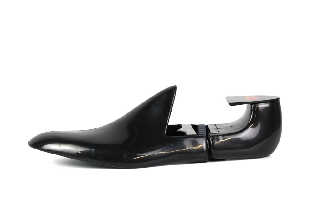 A black plastic shoe tree designed for maintaining the shape of shoes.