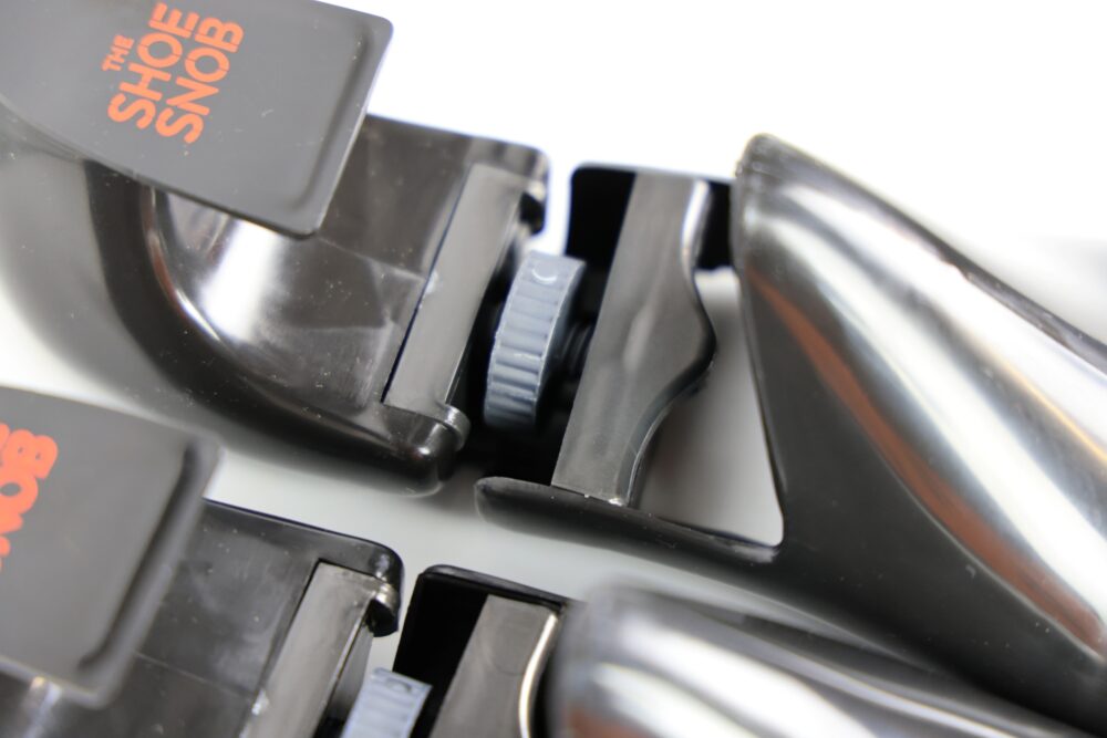 Two black shoe trees with red branding, featuring a gray adjustment knob.