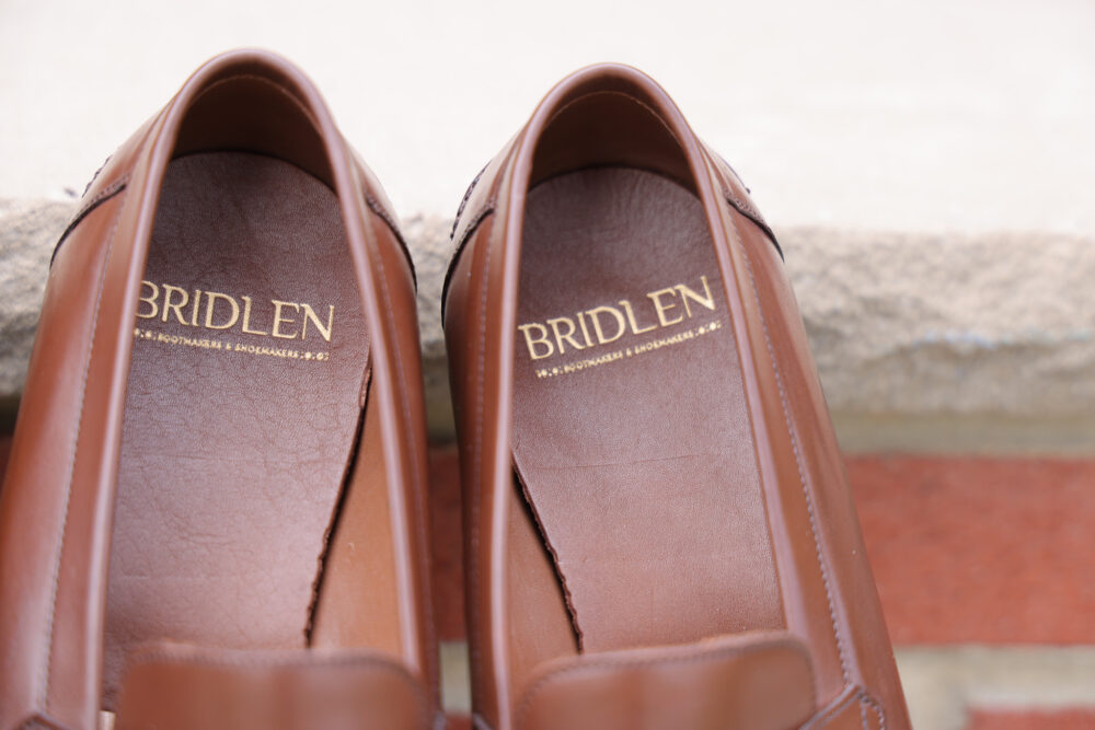 A pair of brown leather shoes with "BRIDLEN" embossed on the insoles.