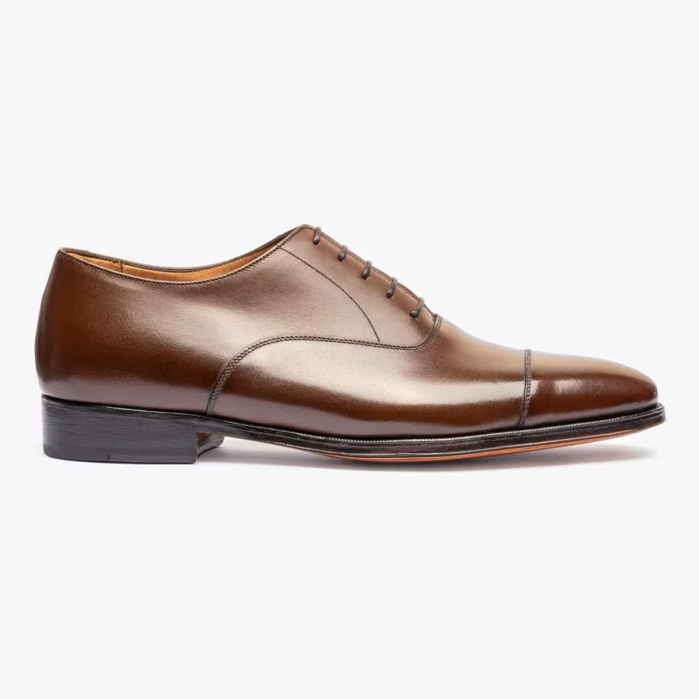 A polished brown leather dress shoe with a rounded toe and lace-up design.