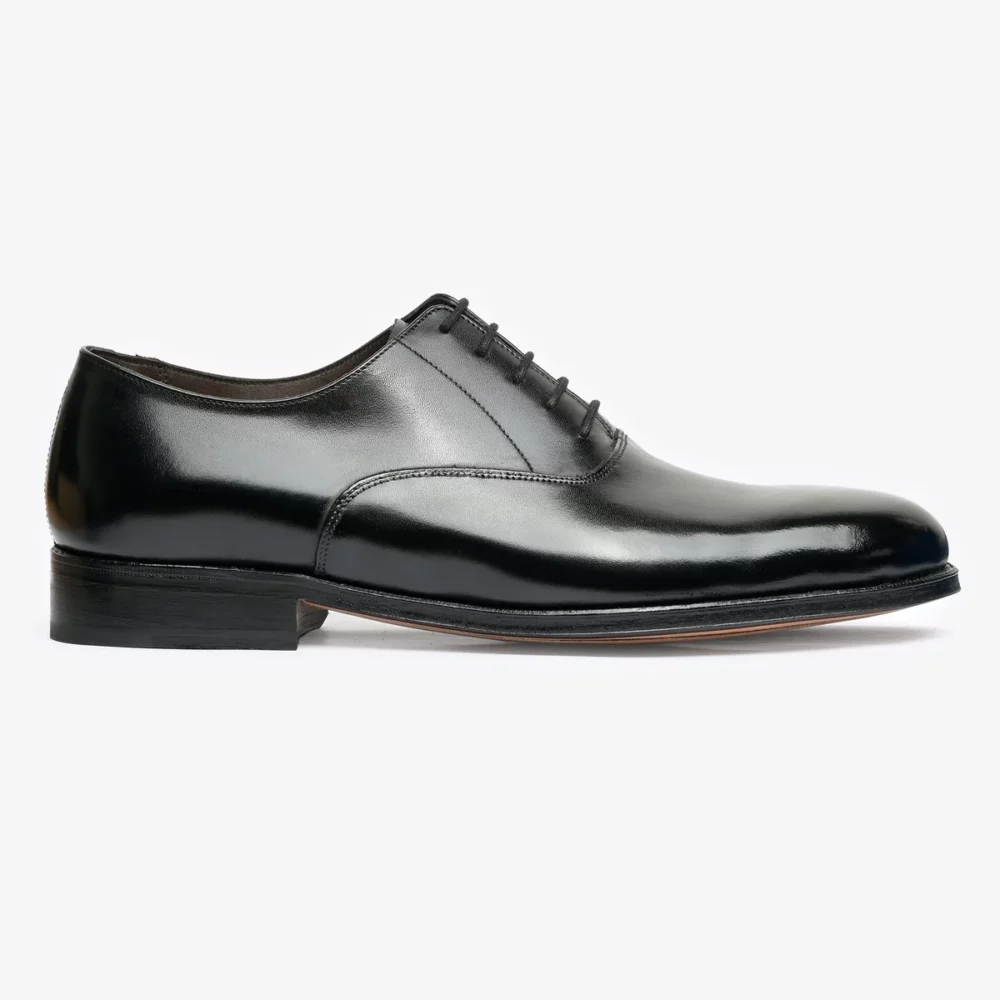 A sleek black leather dress shoe with a smooth finish and six eyelets for laces.