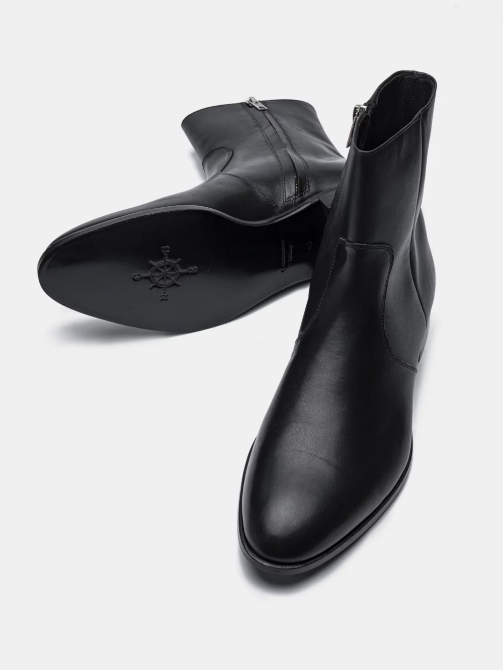A pair of CNES black leather ankle boots with a side zipper.