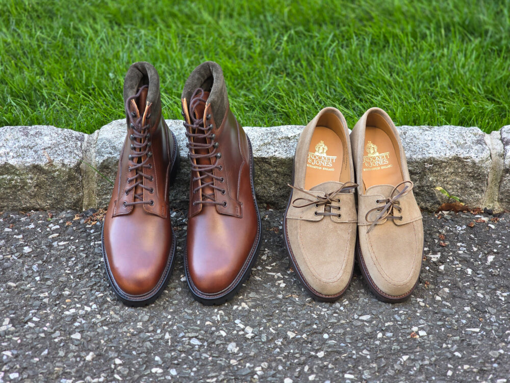 A pair of brown leather boots and a pair of tan suede shoes placed side by side.