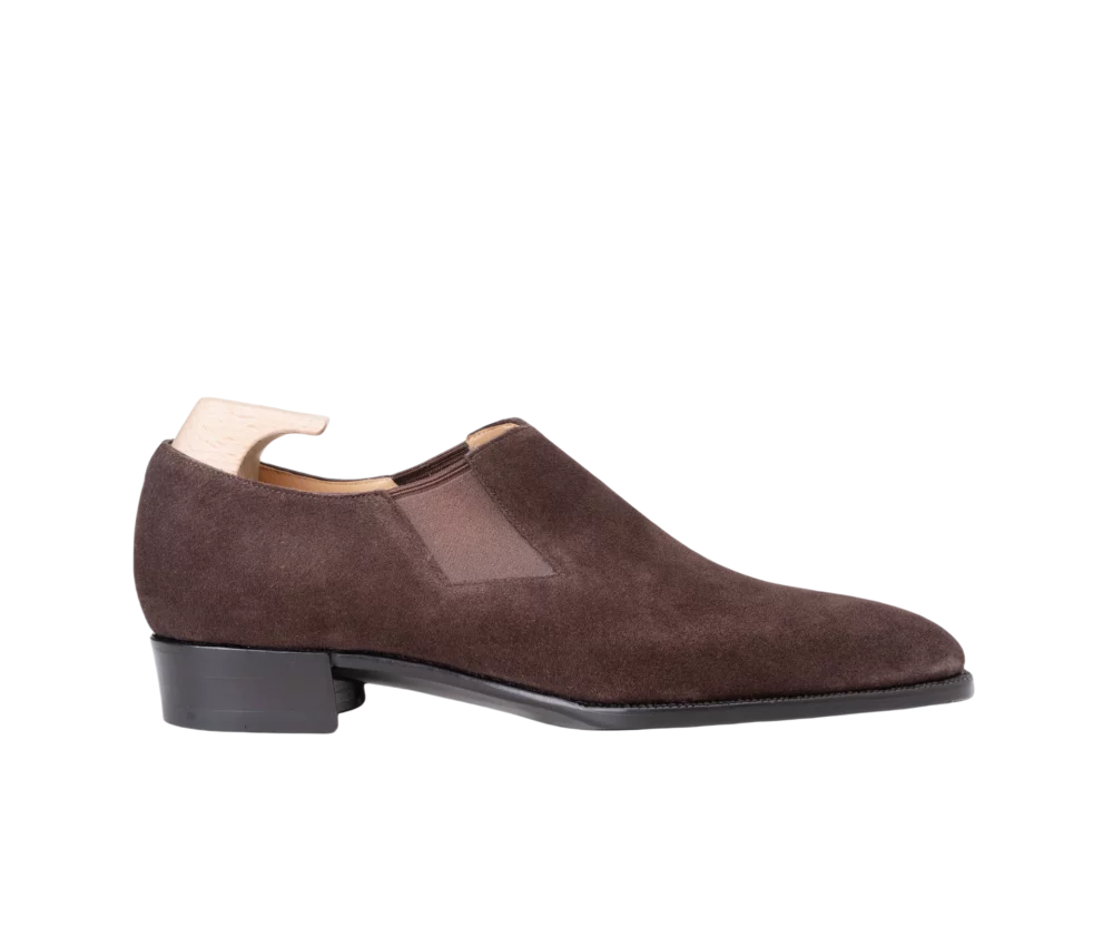 Brown suede ankle boot with a low heel and elastic side panels.