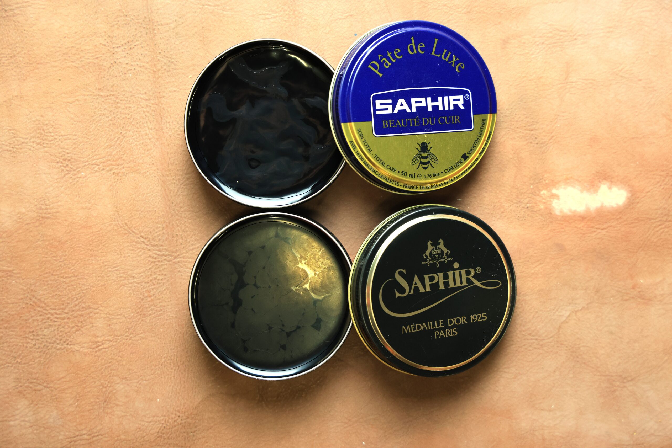 Two open tins of Saphir pate de luxe wax polish from the MDO and BDC lines
