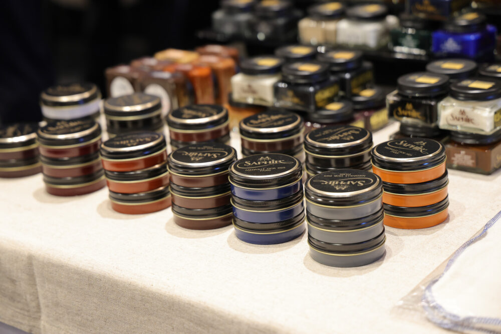 A collection of round jars in various colors, primarily browns and blues, labeled with "Saphir."