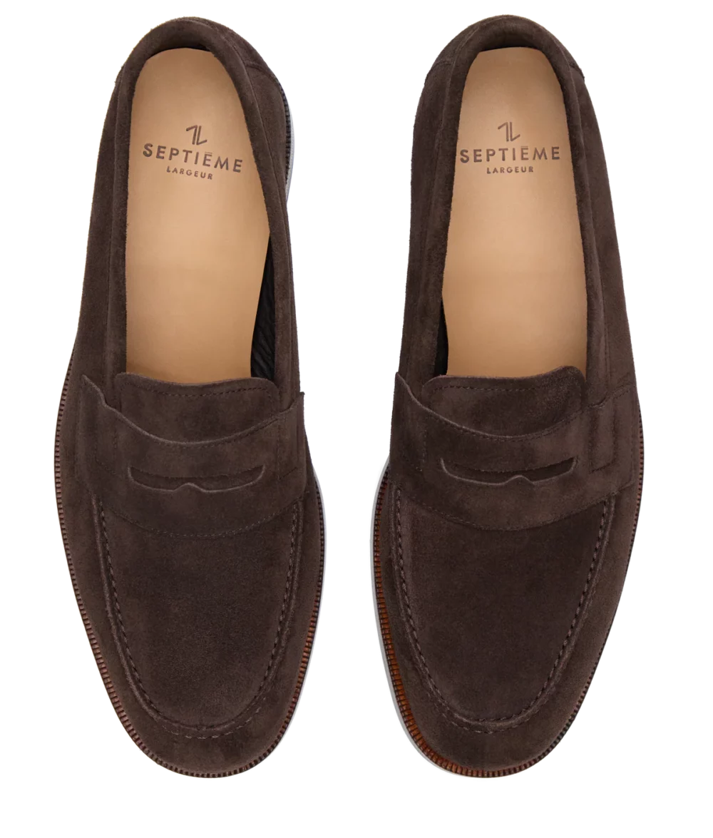Brown suede loafers with a decorative strap and a tan insole.