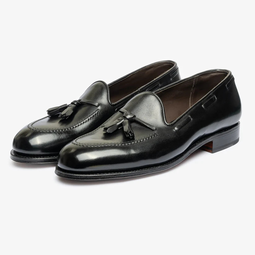 A pair of black leather loafers with tassels.