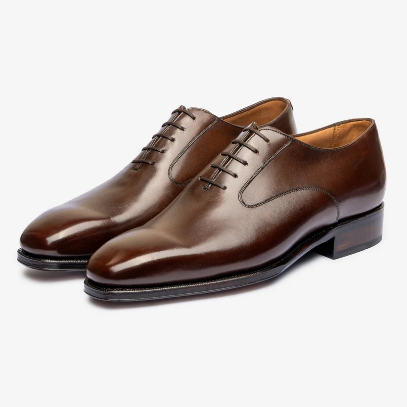 Brown leather dress shoes with a polished finish and lace-up design.