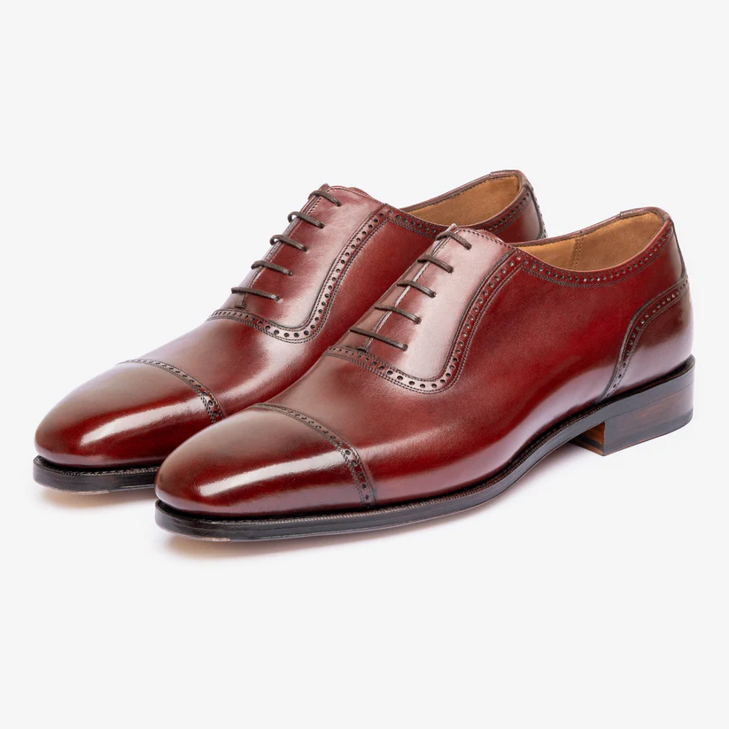 A pair of polished burgundy leather dress shoes with a cap toe and decorative stitching as part of the Bridlen Spring Promotion
