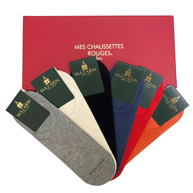 A collection of five pairs of socks in gray, white, black, blue, and red, displayed with green labels on a red box.