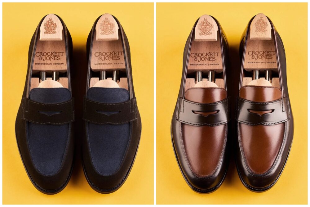Two pairs of Crockett & Jones loafers, one in dark blue suede and the other in brown leather, displayed side by side.