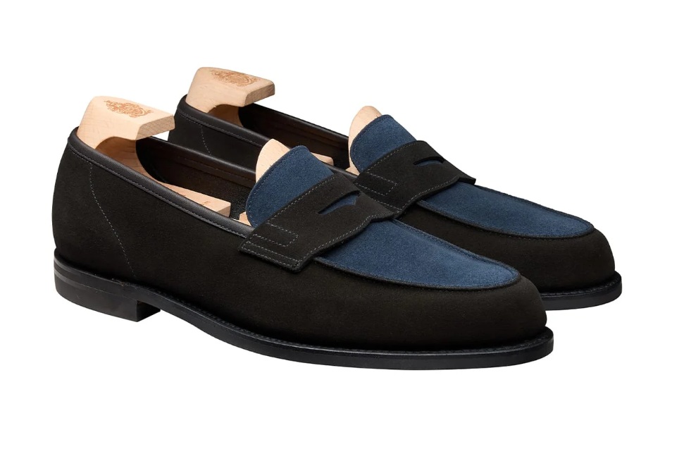 A pair of loafers featuring a dark brown suede body and a blue suede vamp.