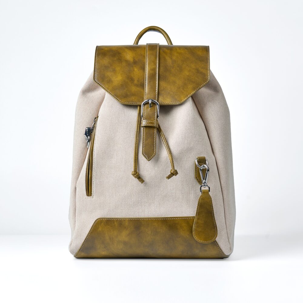 A beige canvas backpack with a yellowish-brown leather flap and accents.