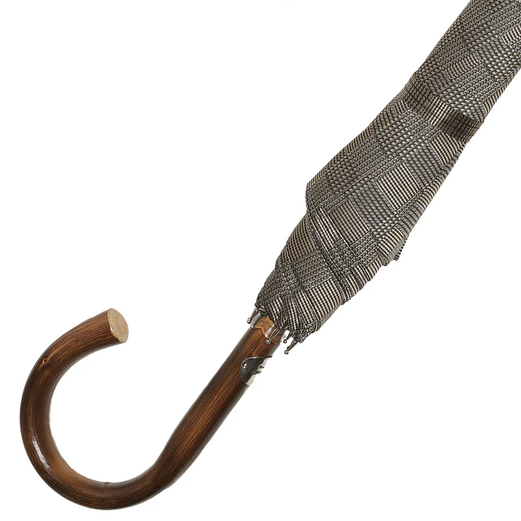 A brown wooden-handled umbrella with a patterned black and gray canopy.