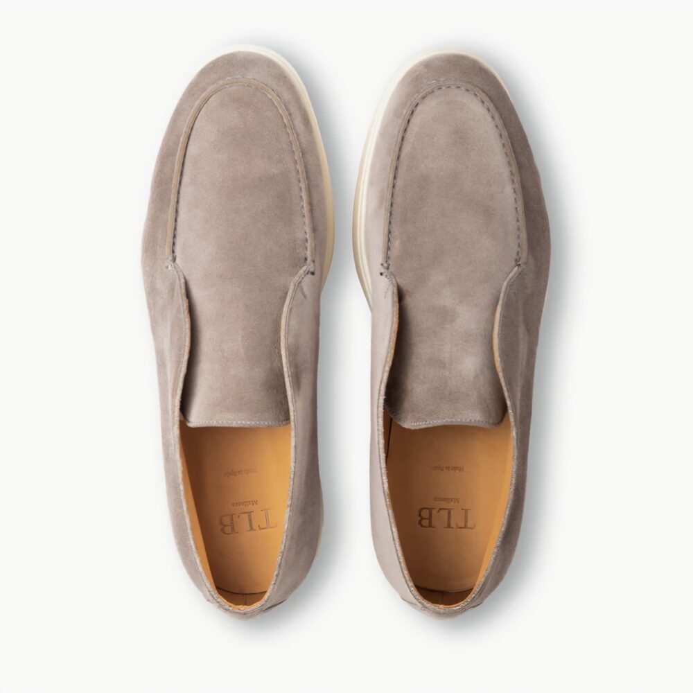 A pair of gray suede slip-on shoes with a light-colored sole.