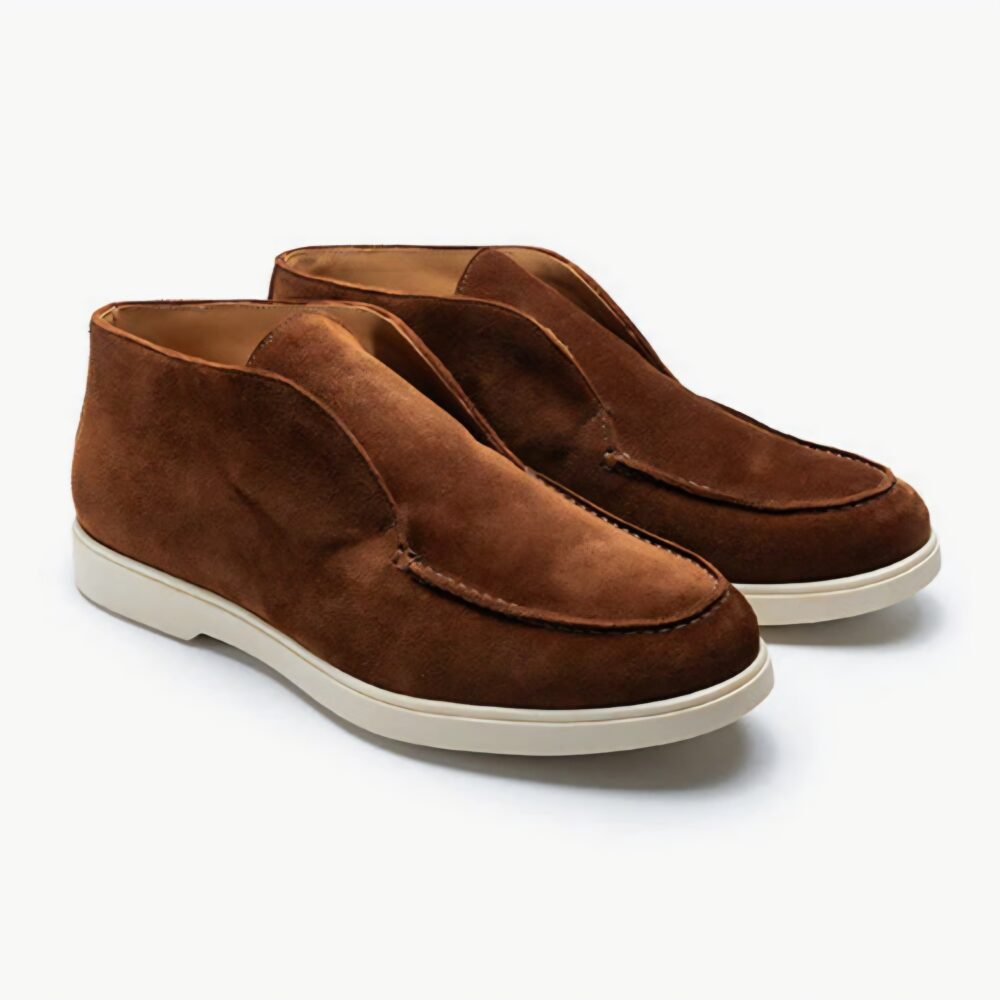 A pair of brown suede slip-on shoes with a white rubber sole.