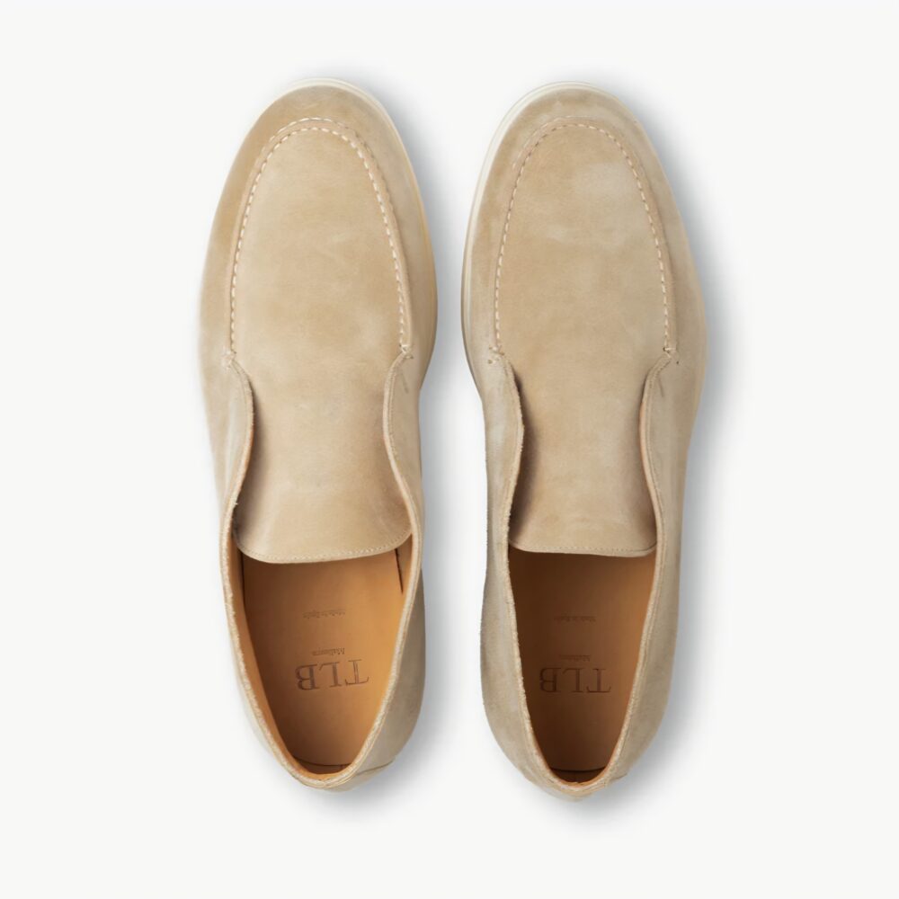 A pair of beige suede TLB Mallorca Laceless Ankle Boots with a stitched design.
