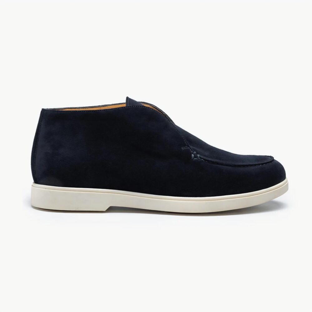 Navy suede ankle boots with a white rubber sole.