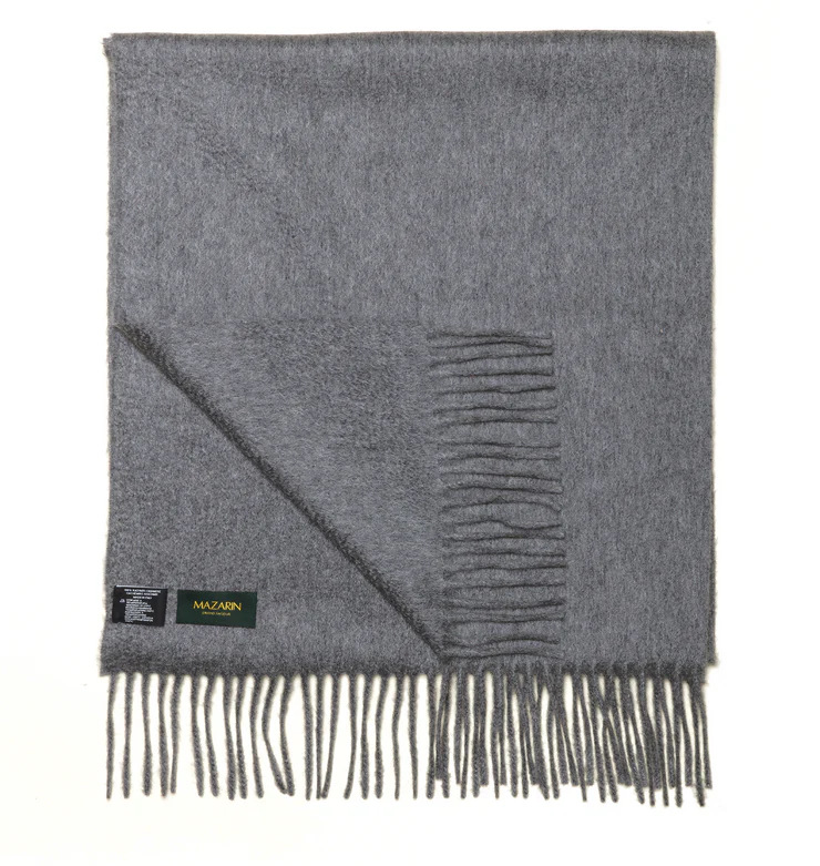 A gray scarf with frayed edges and a small label.