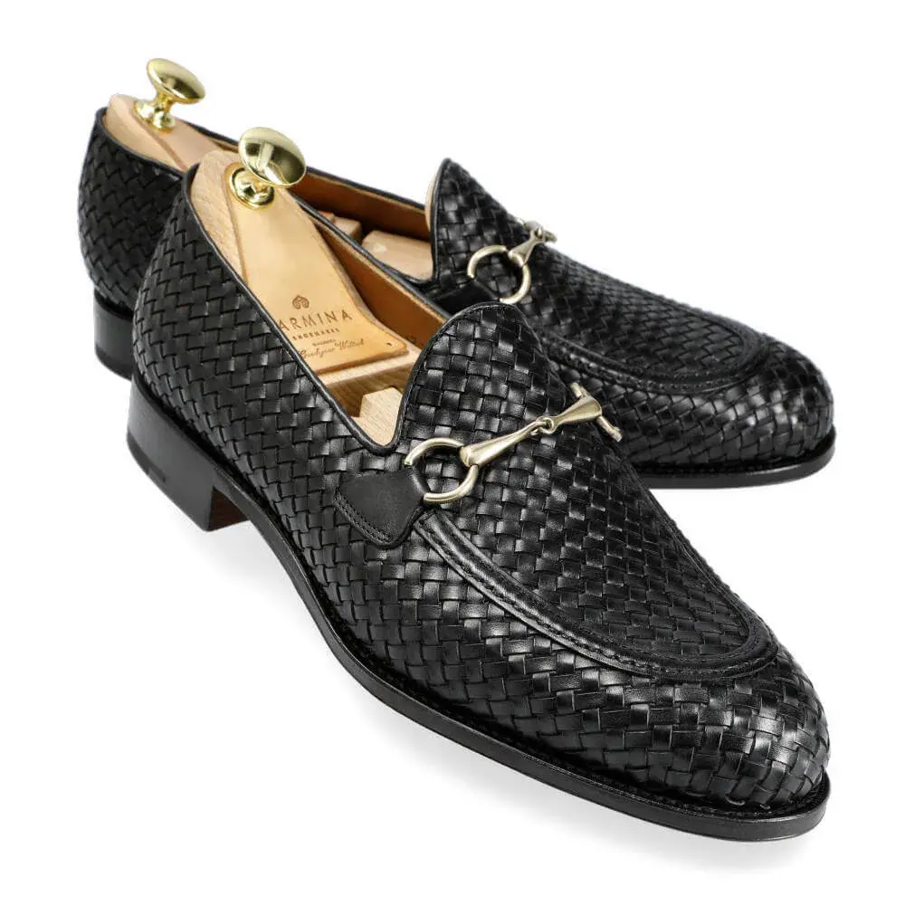 Black woven leather loafers with a gold buckle detail.
