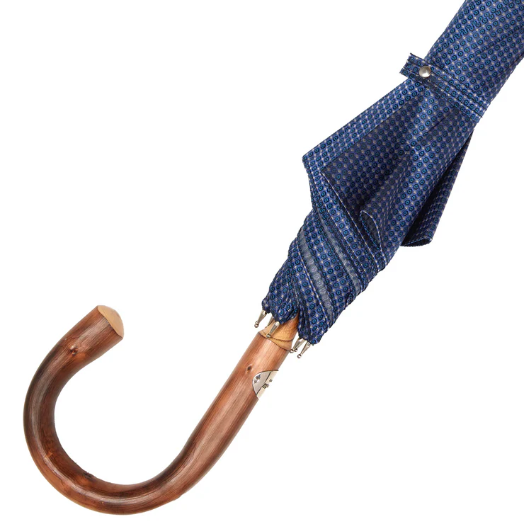 A blue patterned umbrella with a wooden curved handle.