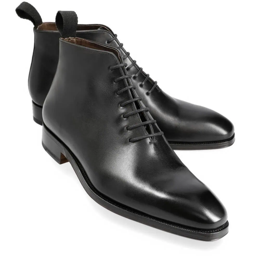 A pair of black leather ankle boots with a pointed toe and lace-up design.