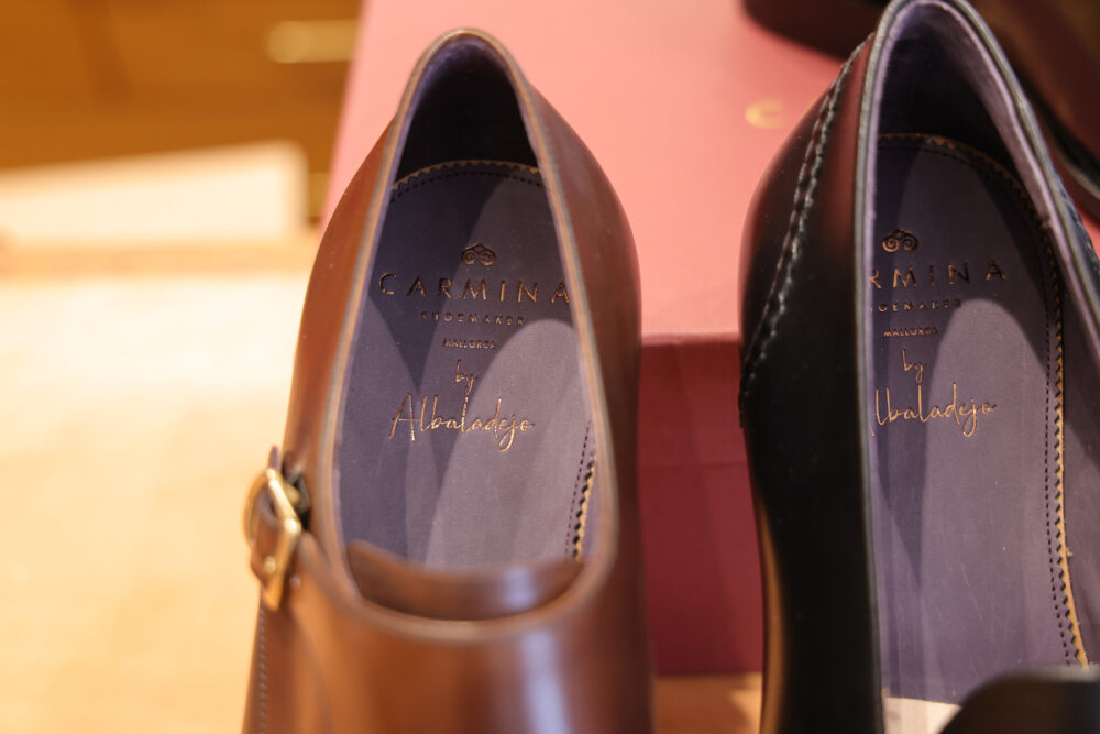 Alt text: Two pairs of leather shoes, one brown and one black, with visible branding on the insoles.