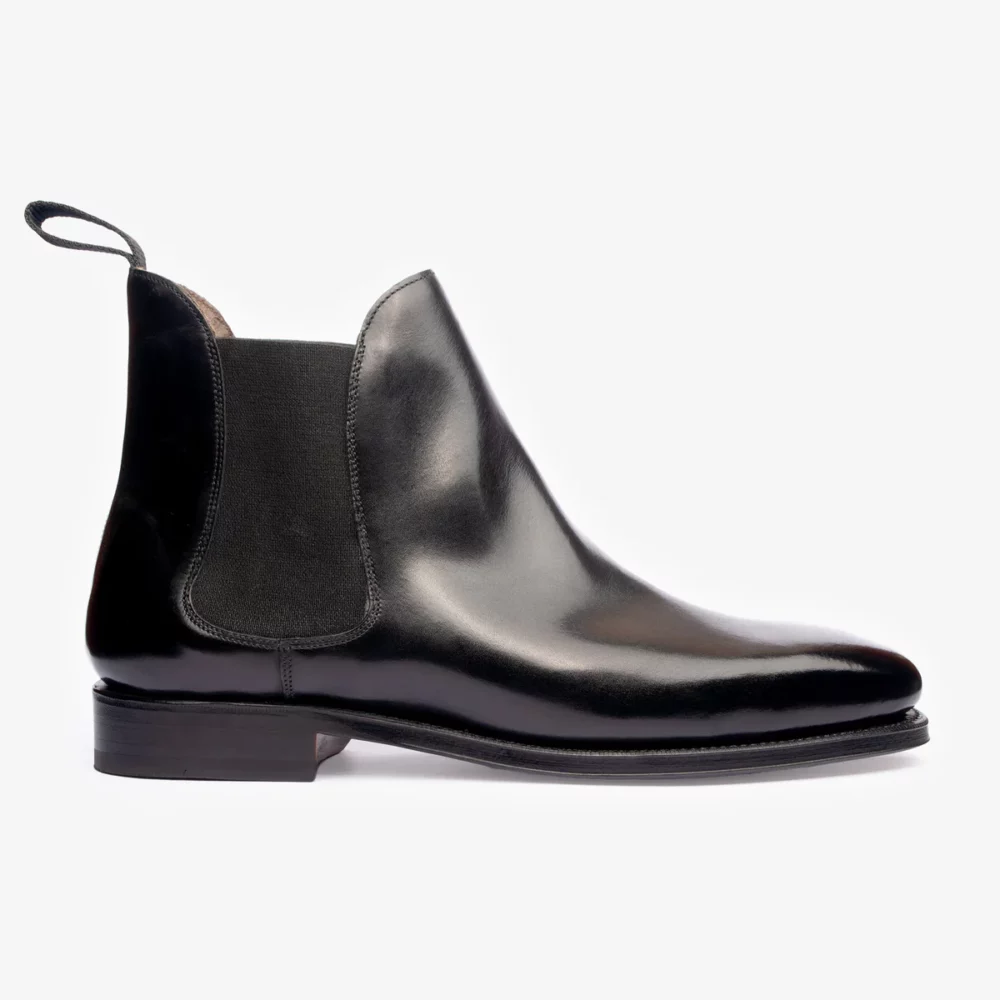A sleek black leather Chelsea boot with elastic side panels.
