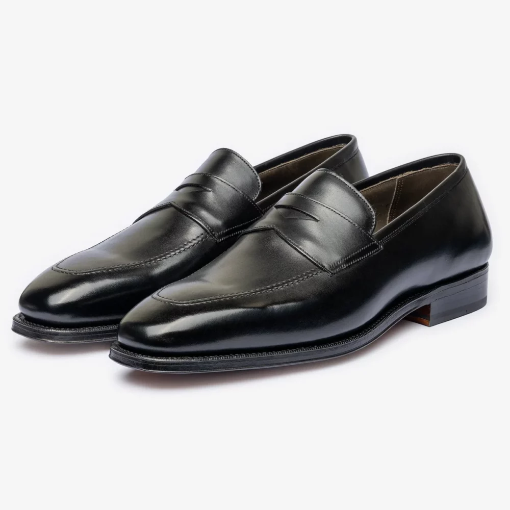A pair of black leather loafers with a sleek design and a low heel.