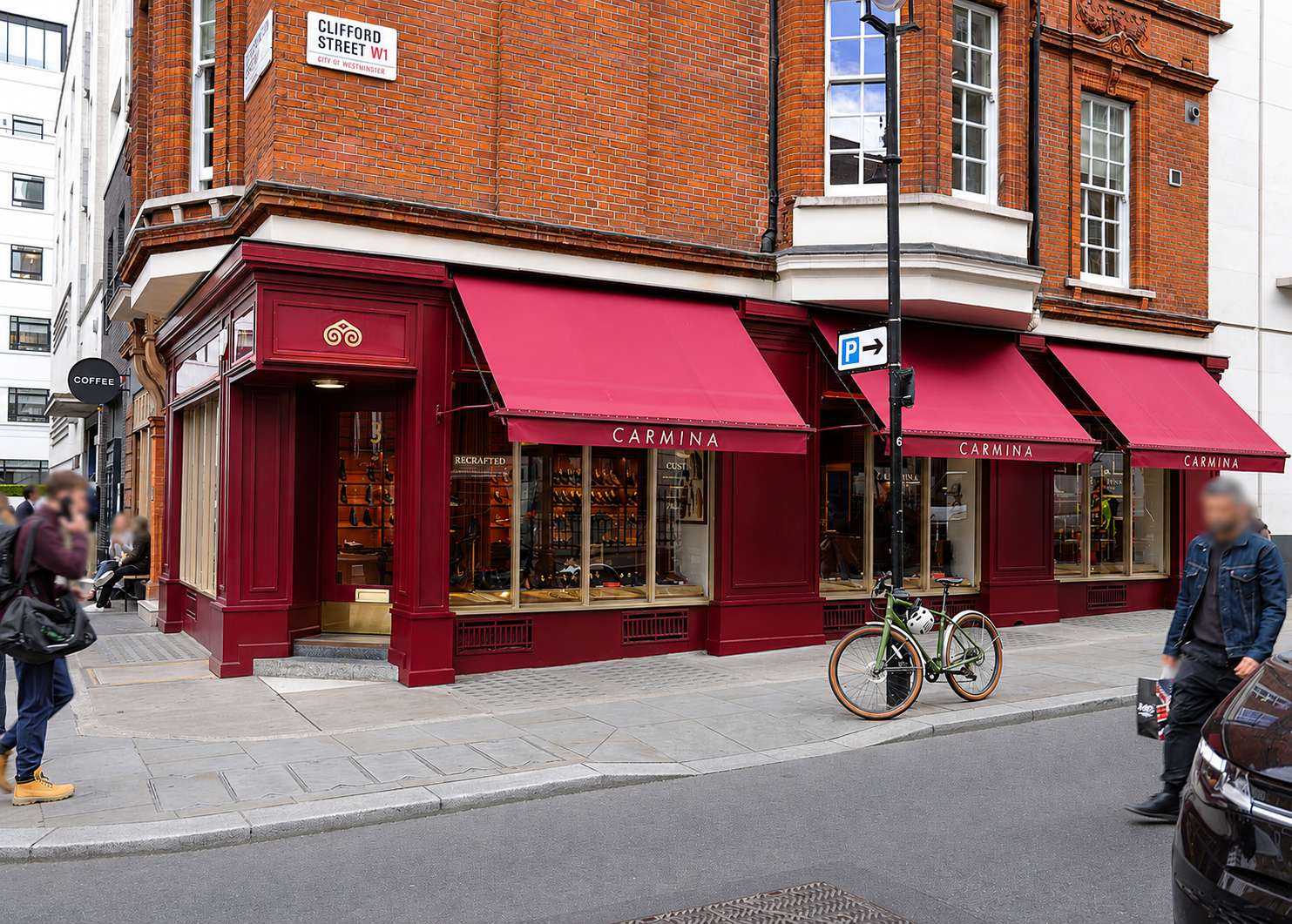 A burgundy storefront with the name "CARMINA" displayed above large windows showcasing shoes.