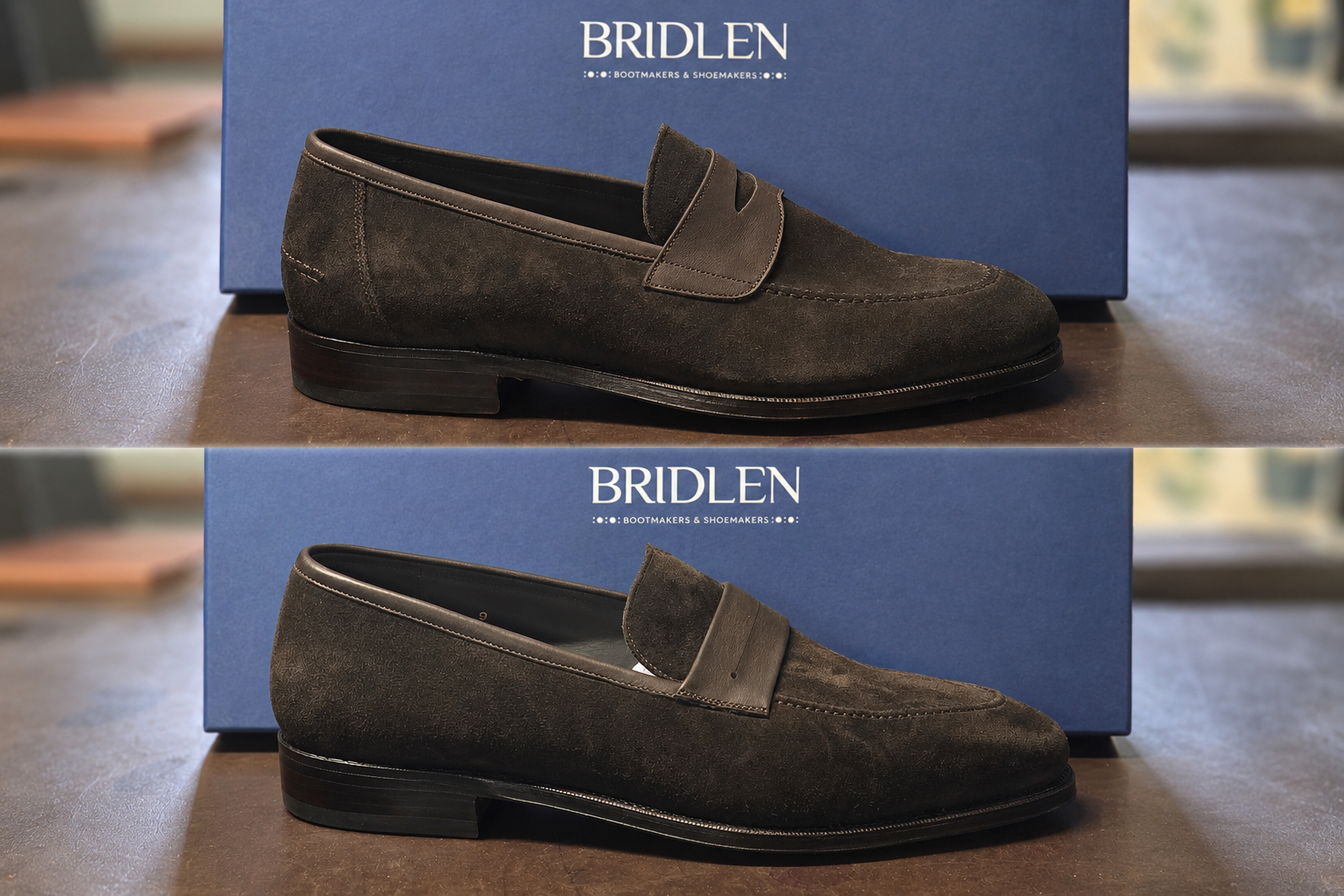 A pair of dark brown suede loafers with a leather strap detail, displayed against a blue background.