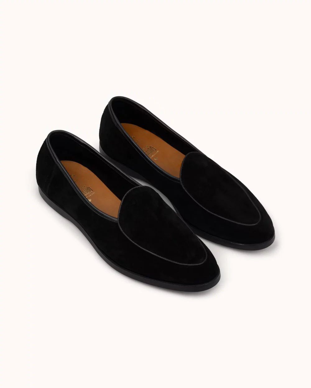 Black suede loafers with a smooth finish and a rounded toe.