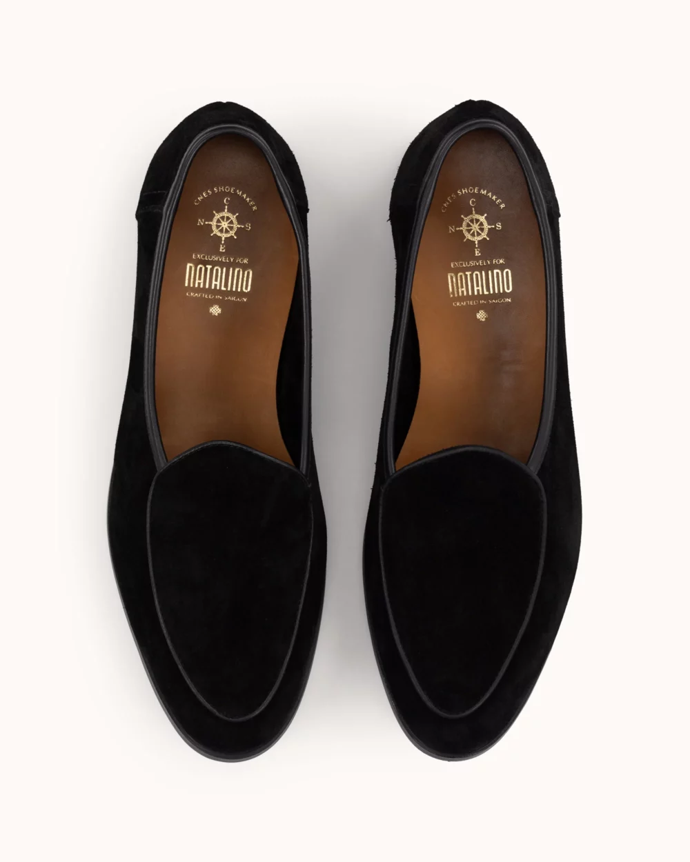 Black suede loafers with a smooth finish and a leather interior.