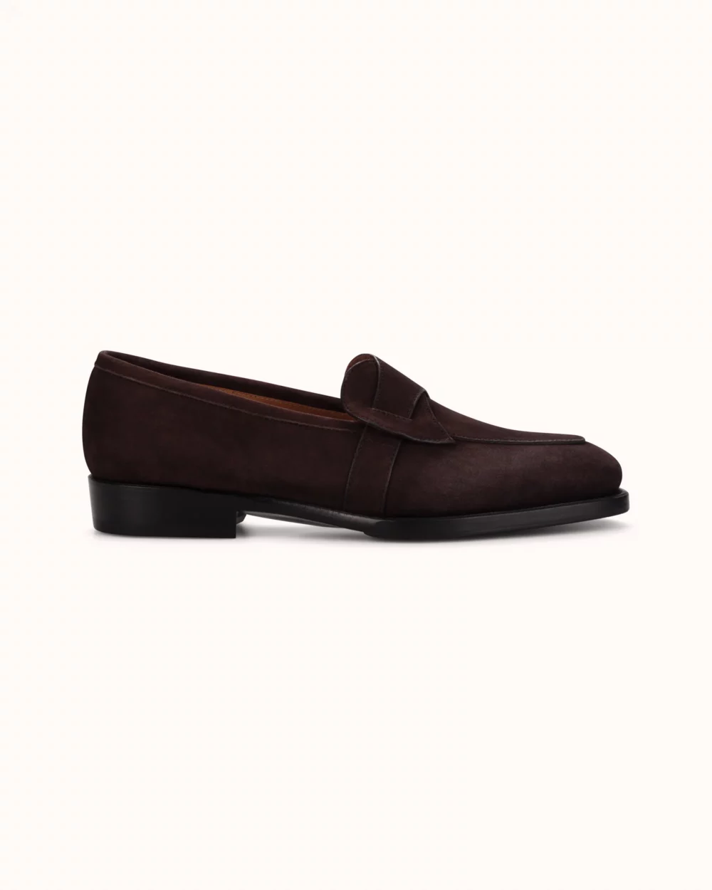 Dark brown suede loafer shoe with a flat heel.