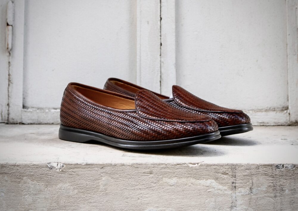 Brown woven loafers with a smooth black sole.